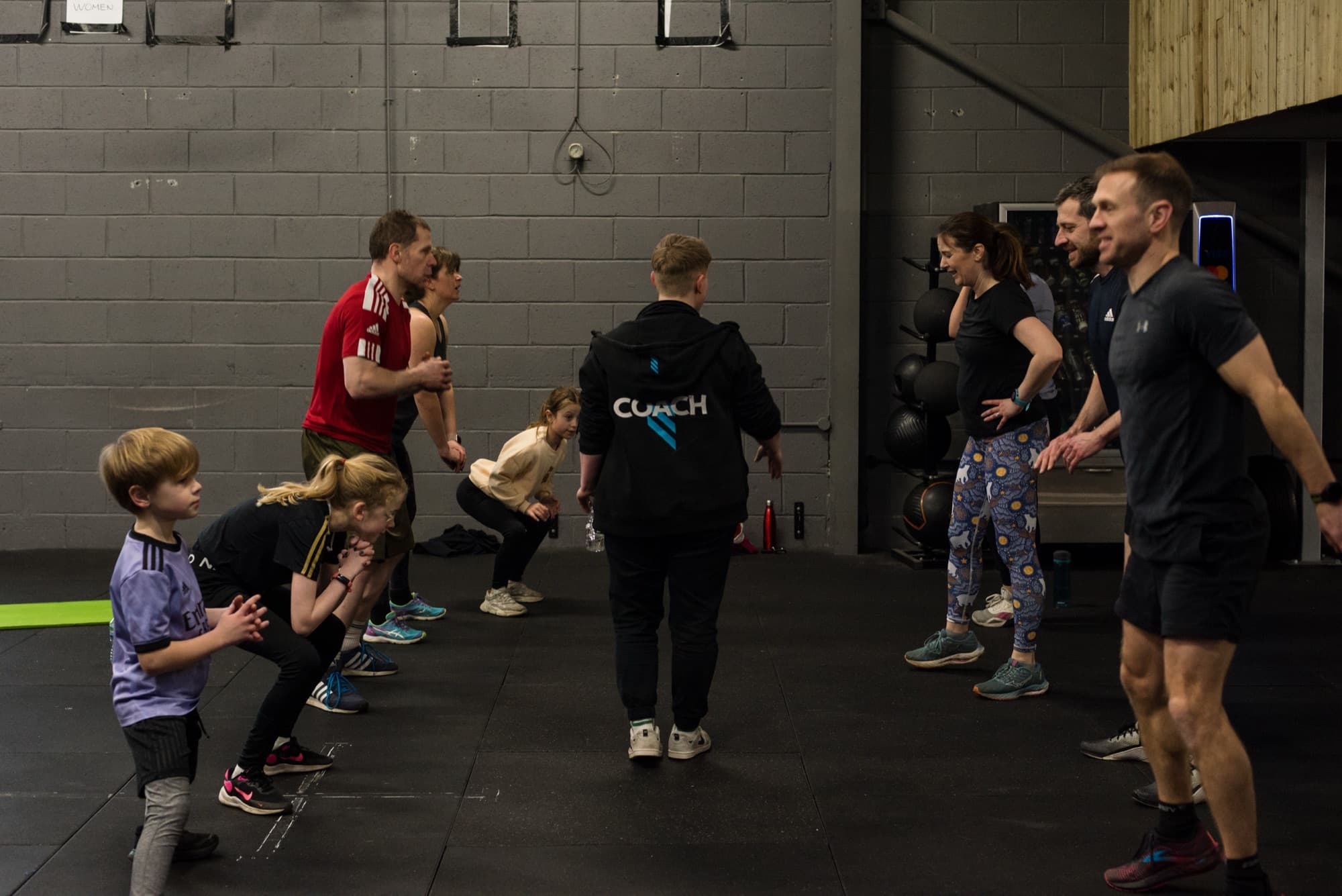 A multi-generational family training together in a class